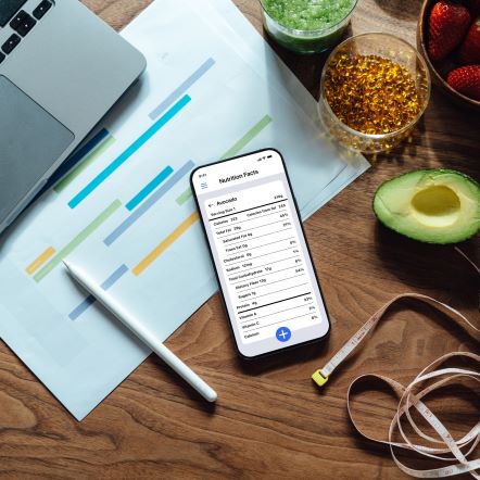 Phone sitting amongst fruits and vegetables